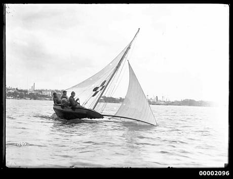 10 footer on Sydney Harbour displaying cross-shaped ensign